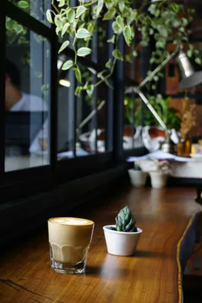Latte in a glass on a cafe table