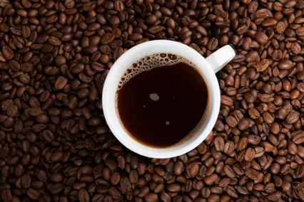 Espresso cup on a bed of coffee beans